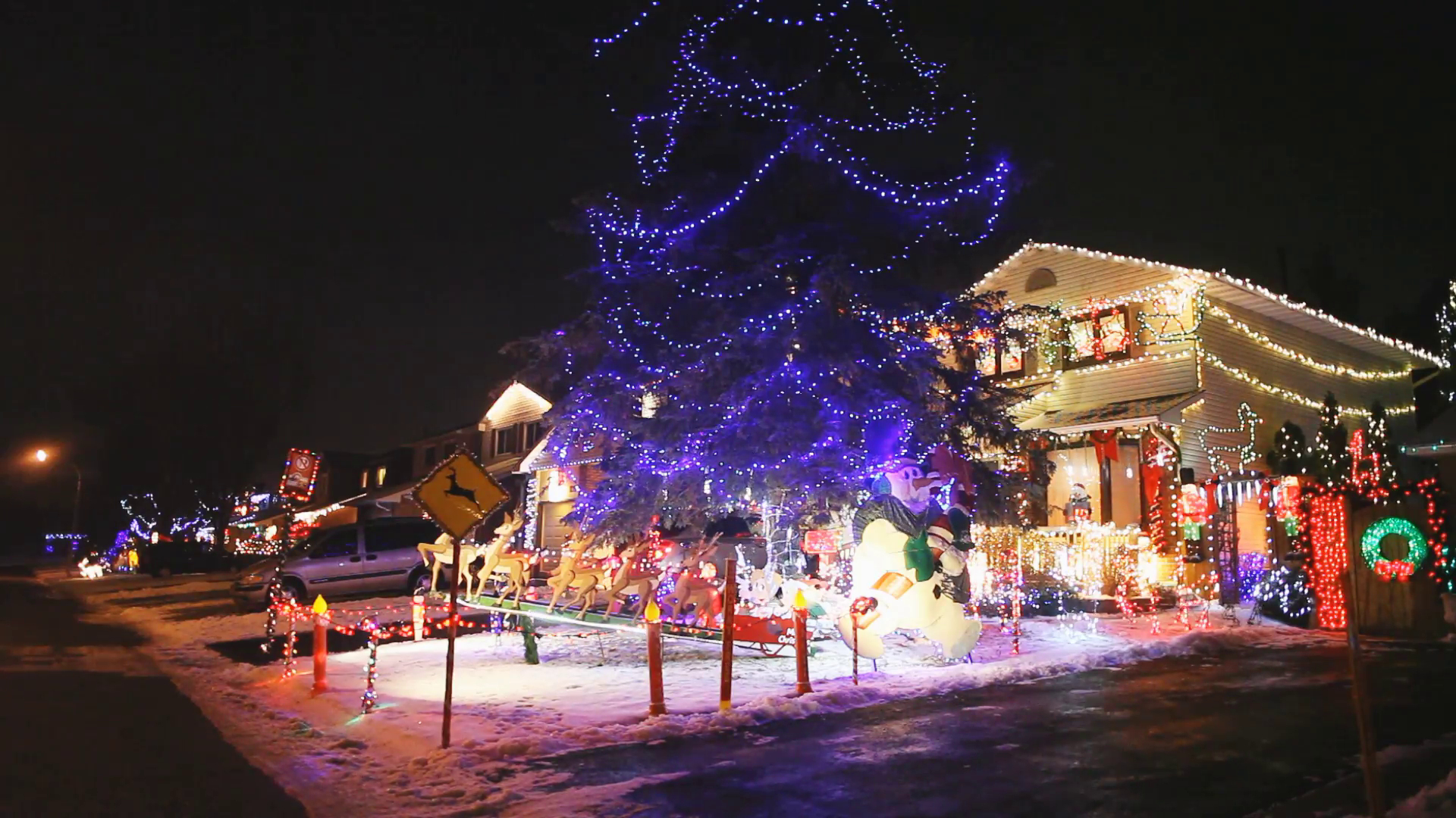 A Street Of Homes At Night With Colourful Christmas Lights Snow On pertaining to proportions 1920 X 1080