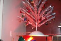 An Aluminum Christmas Tree Illuminated A Revolving Color Wheel in sizing 768 X 1024