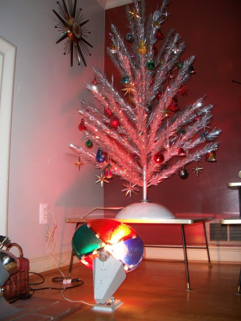 An Aluminum Christmas Tree Illuminated A Revolving Color Wheel in sizing 768 X 1024